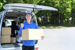 清潔感のある服装で笑顔を見せる軽貨物ドライバー